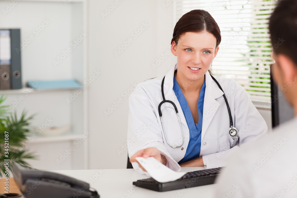 Female doctor giving patient prescription Female doctor giving patient prescription
