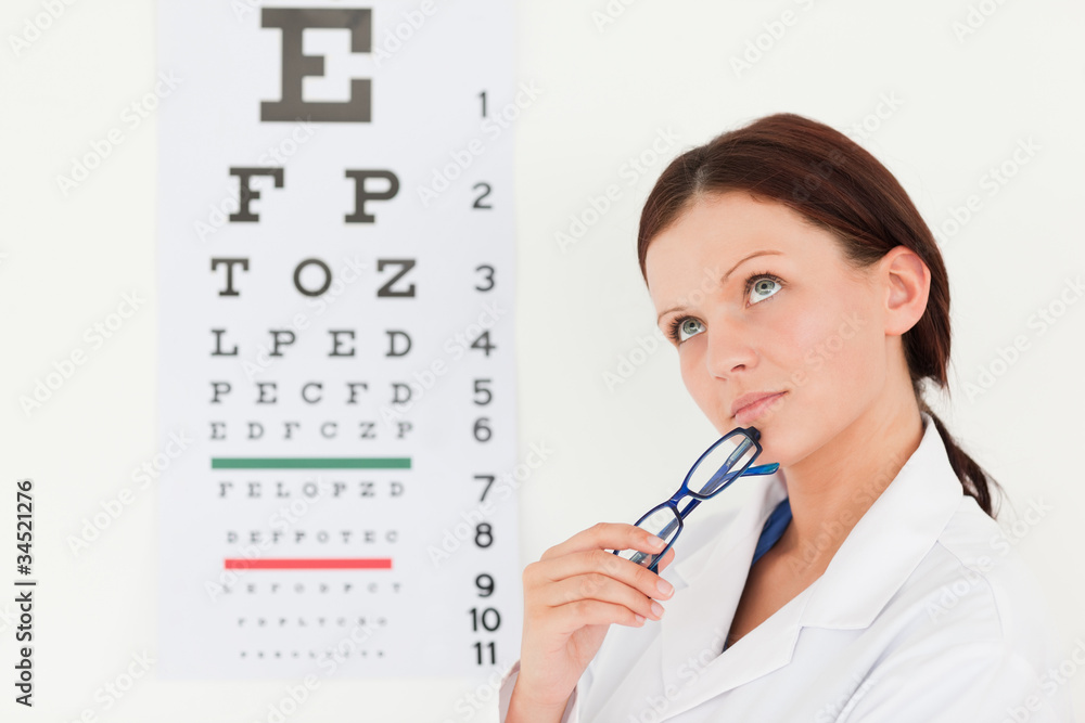 Female optician with eye test in office Female optician with eye test in office