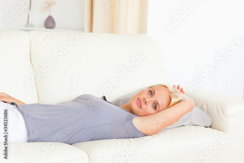 Calm woman lying on a sofa