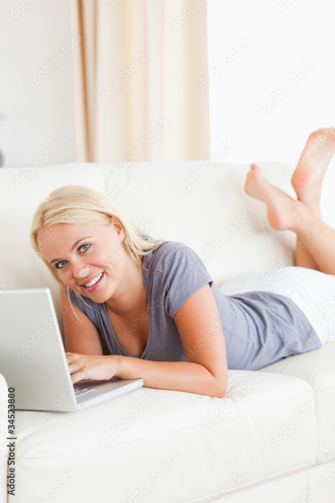 Portrait of a lying blonde woman using a laptop Portrait of a lying blonde woman using a laptop