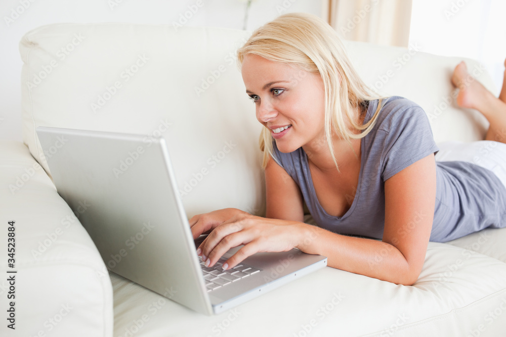 Lying woman using a laptop Lying woman using a laptop