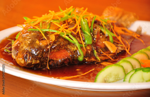 Fried fish served with sechuan sauce. photo