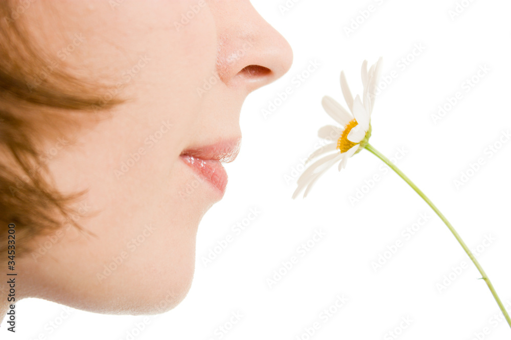 Girl smelling a flower on a white background. - obrazy, fototapety, plakaty 