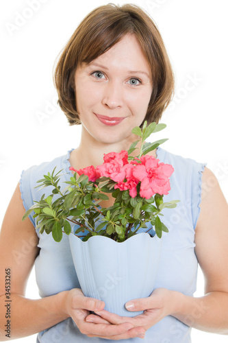 Girl smelling a flower on a white background.