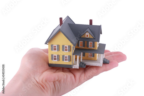 Miniature house over hand isolated