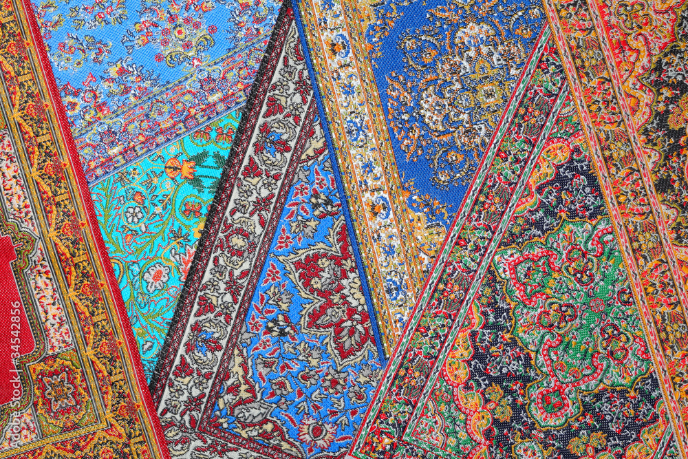 Seven varicoloured carpets lie in random order on each other