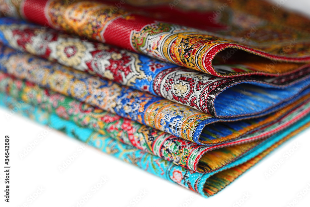 Five bright varicoloured carpets add together in rouleau Five bright varicoloured carpets add together in rouleau