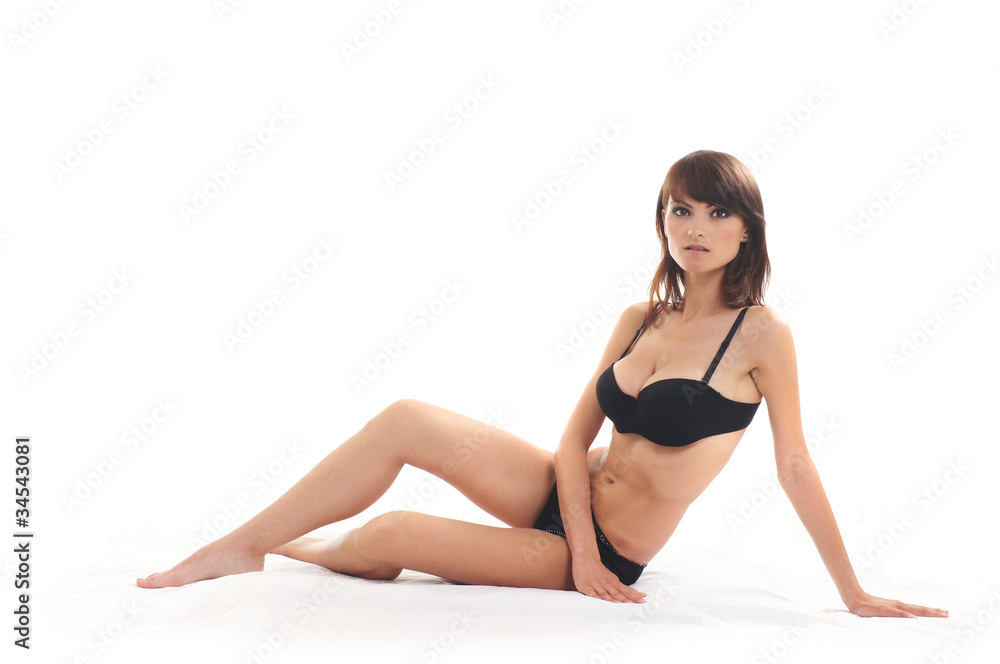 Young sexy woman in black lingerie over white background