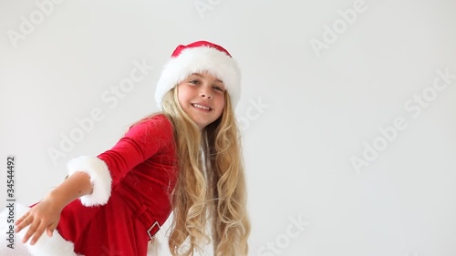 little miss santa looking from sides and below and laughing photo