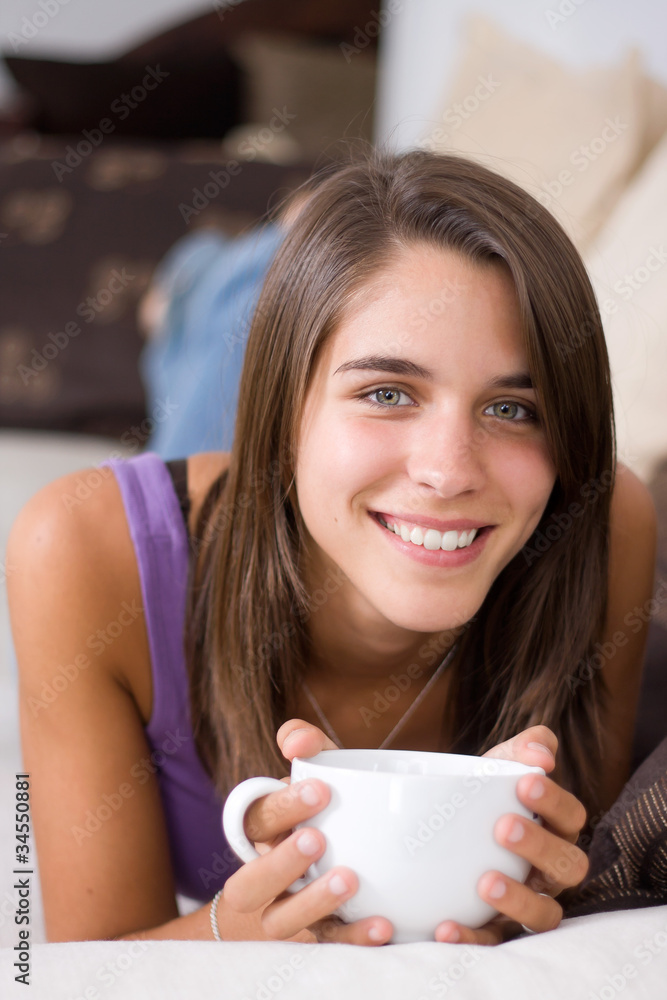 Young attractive woman holding a cup of coffee Young attractive woman holding a cup of coffee