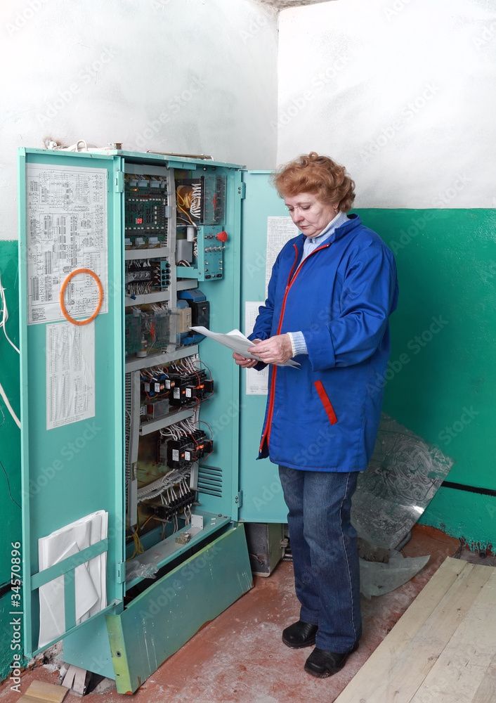 Engineer woman in machine room (elevator) . Engineer woman in machine room (elevator) .