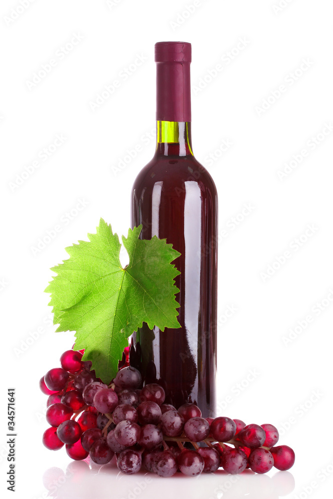bottle of red wine and grapes isolated on white