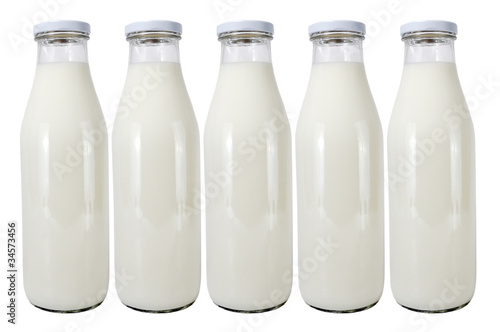 five glass bottles with milk
