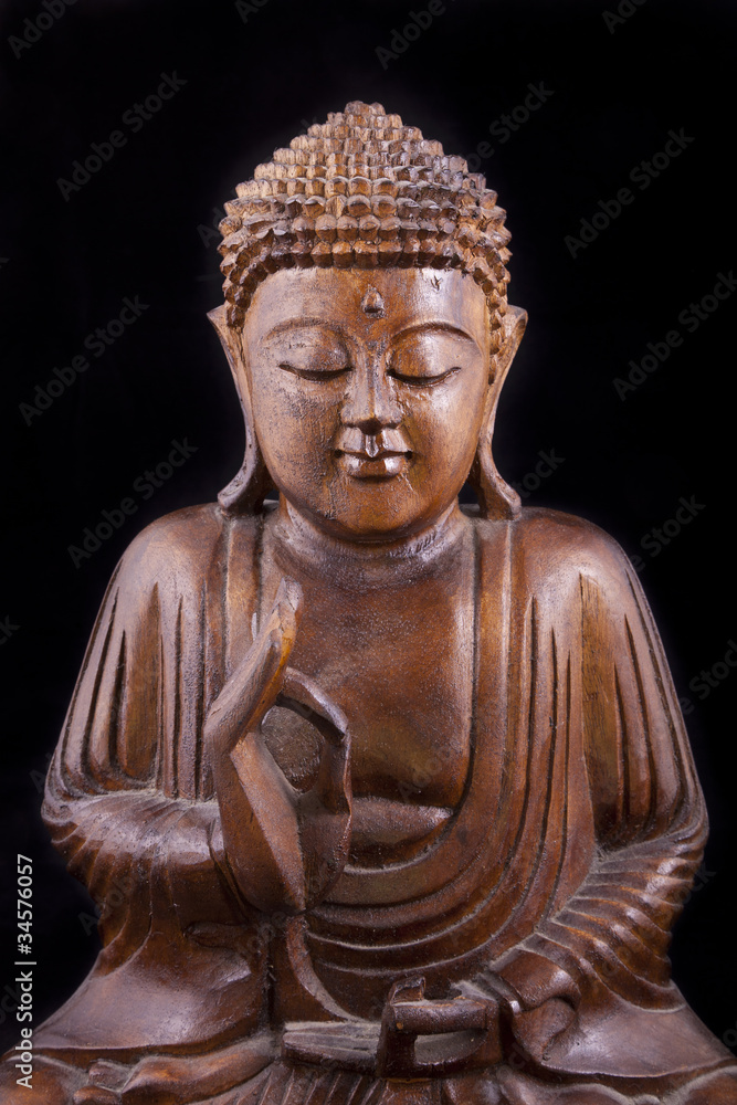 Wooden Buddha on black background