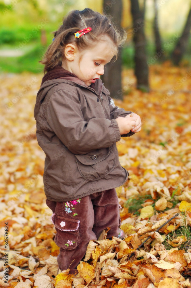 Full lenght portrait of adorable baby girl in autumn forest Full lenght portrait of adorable baby girl in autumn forest