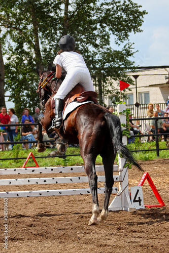 Competitions on concours - the woman jumps through a barrier
