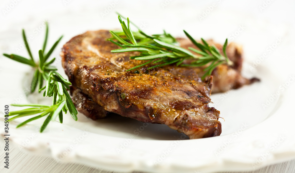 Grilled pork with rosemary sprigs