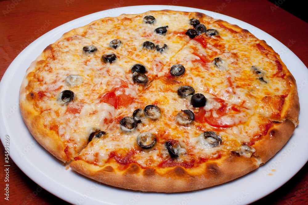 Pizza with black olives and melted cheese, close-up Pizza with black olives and melted cheese, close-up