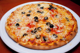 Pizza with black olives and melted cheese, close-up