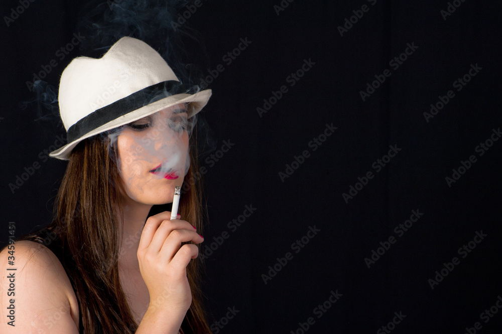Girl smoking cigarette - low key lighting for effect Girl smoking cigarette - low key lighting for effect