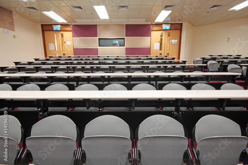 Empty hall for presentation with grey armchairs