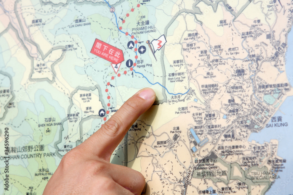 Close up of a hand pointing out location on the map. Close up of a hand pointing out location on the map.