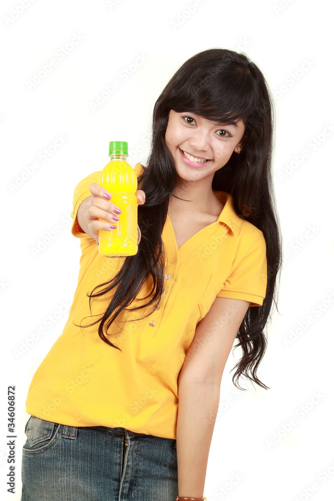 Woman holding orange juice smiling showing orange juice product Woman holding orange juice smiling showing orange juice product