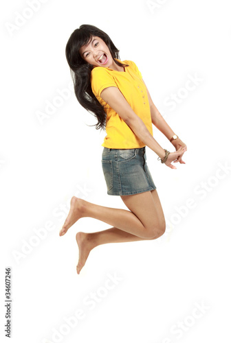 Beautiful girl jumping of happiness isolated on white