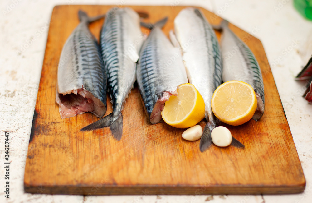 Fish carcass with spices on wooden hardboard, prepared for cooki Fish carcass with spices on wooden hardboard, prepared for cooki