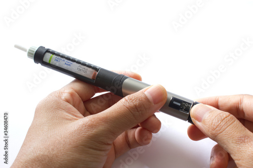 Two hands setting up an insulin penfill