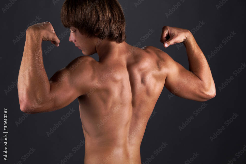 Tanned muscular young man, power bodybuilding Tanned muscular young man, power bodybuilding
