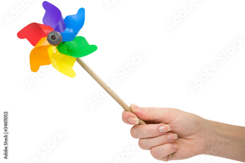 hand with a color pinwheel over a white background.