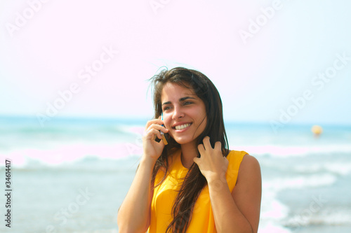 Smiling young lady talking on a cellphone