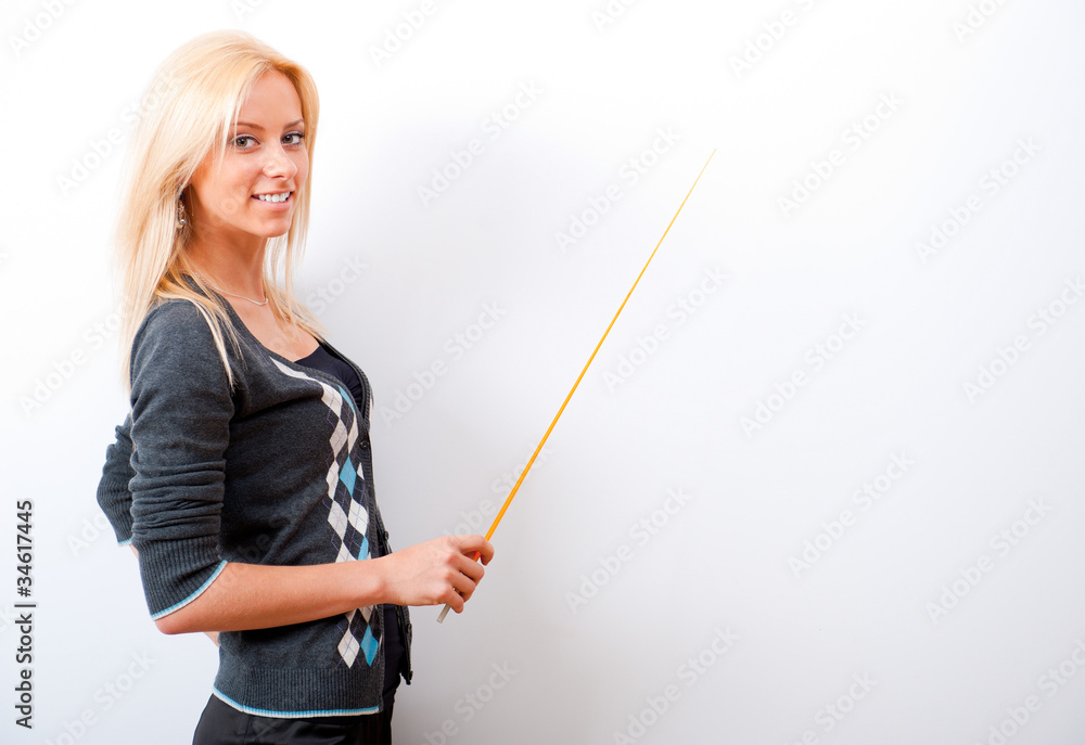 Portrait of young teacher pointing on white marker board in mode Portrait of young teacher pointing on white marker board in mode
