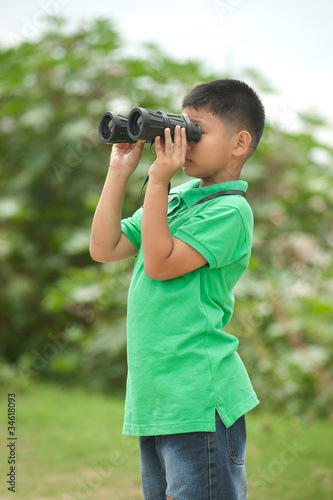Boy looking into binocular.