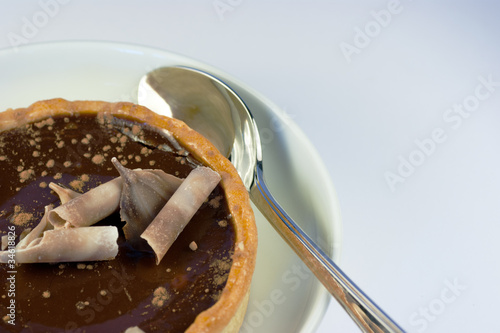 A delicious rich chocolate tart and a silver spoon