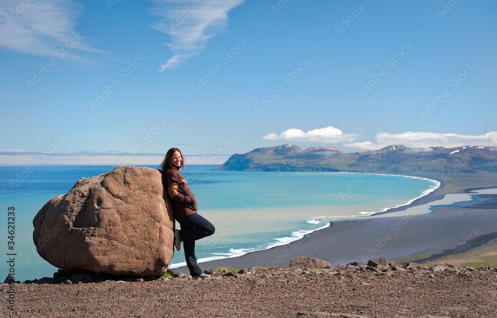 young woman posing by the rock, Iceland