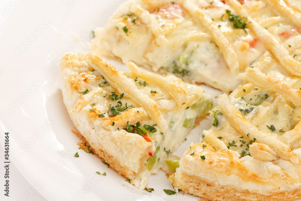 tasty quiche with cheese and herbs