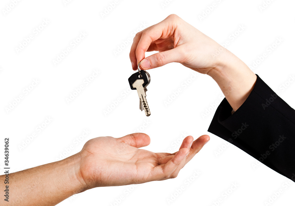 Hand of businessman passing a set of keys to another hand Hand of businessman passing a set of keys to another hand