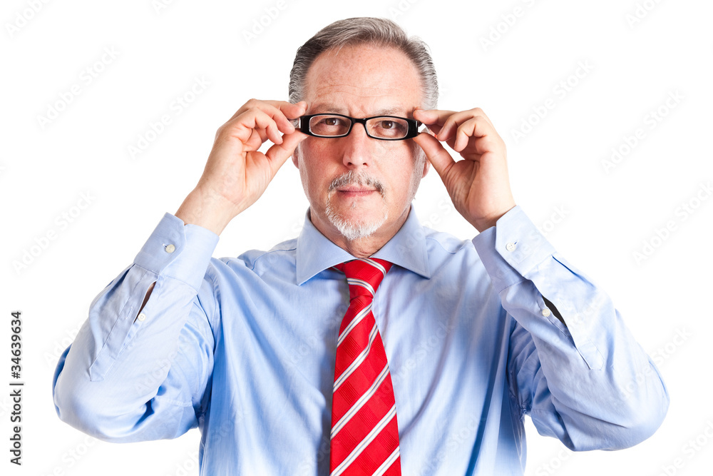 Mature businessman adjusting his glasses Mature businessman adjusting his glasses