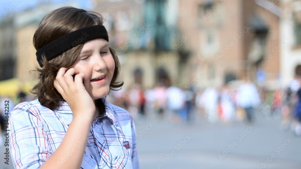Young boy talking on mobile phone in the city Young boy talking on mobile phone in the city