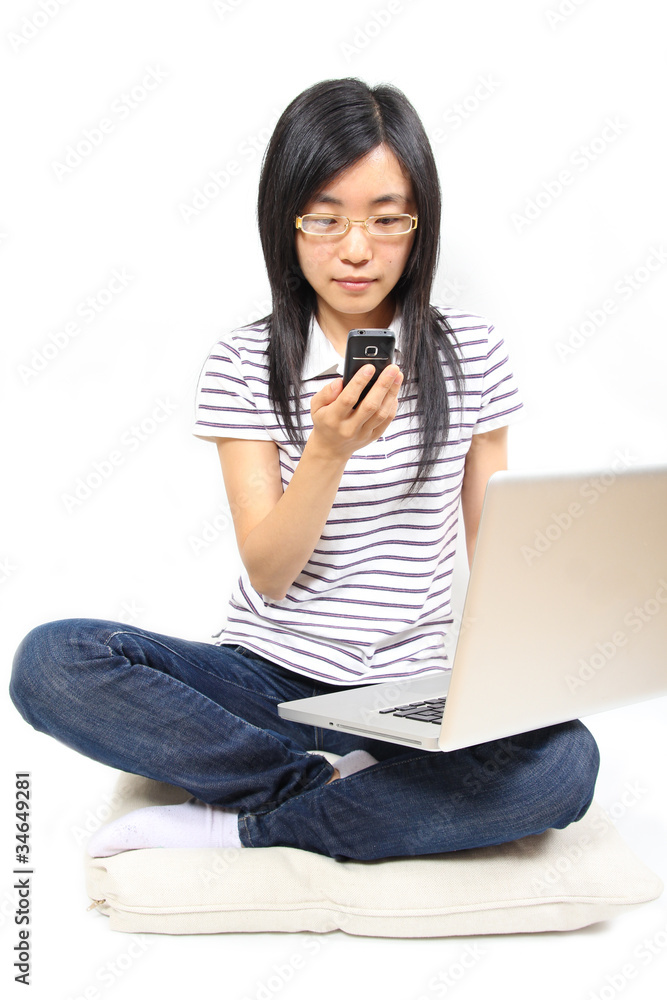 Young chinese woman sitting on the floor with laptop