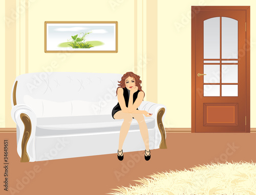 Sitting woman on the white sofa in the living room