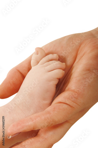 Mothers hand holding a babys foot