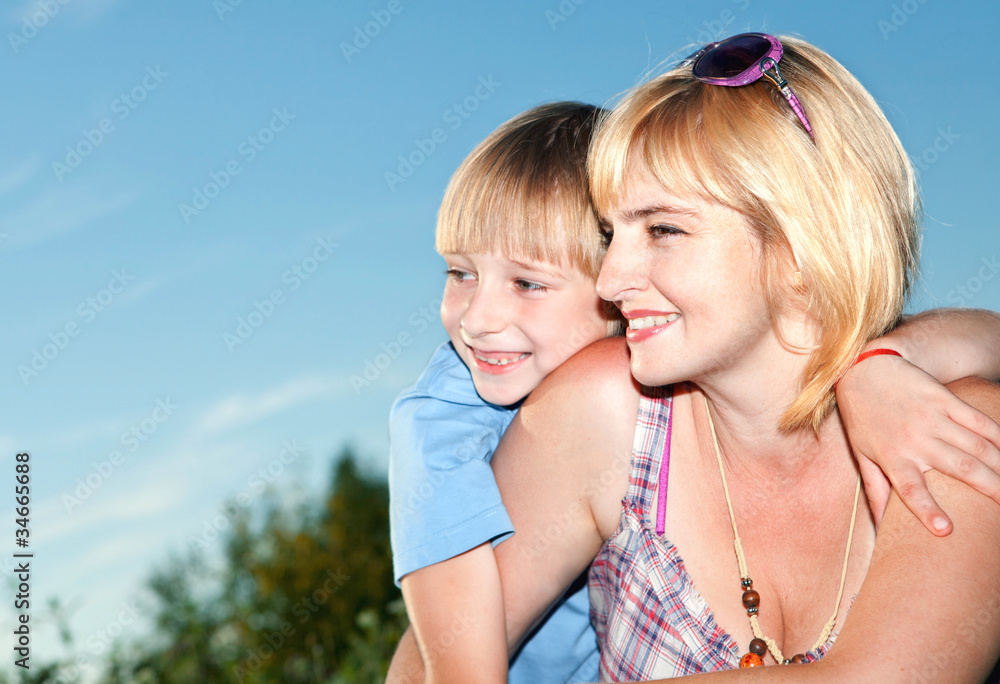 The mother with small son against sky The mother with small son against sky
