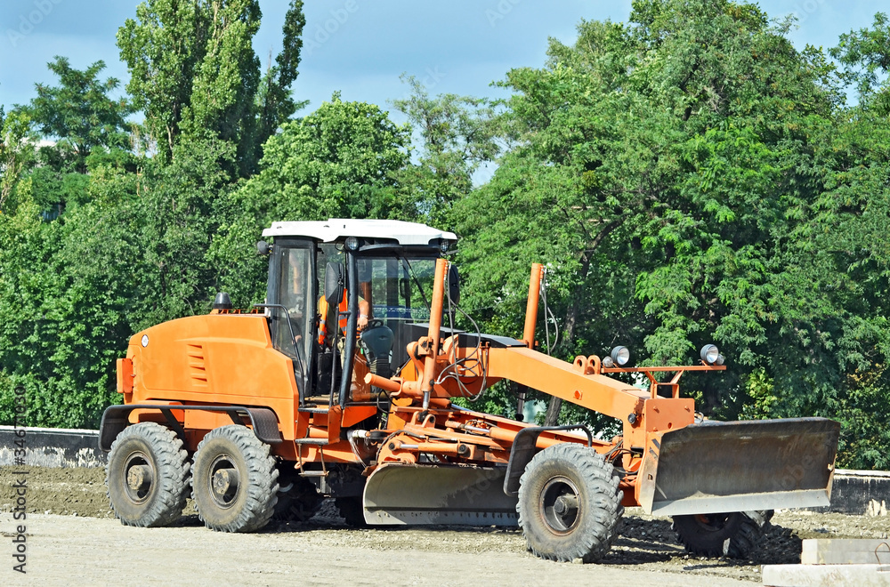 Orange bulldozer on bridge road construction site