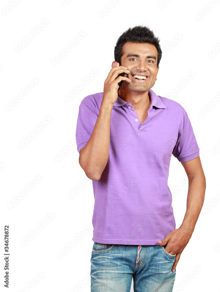 young man smiling using a mobile phone young man smiling using a mobile phone