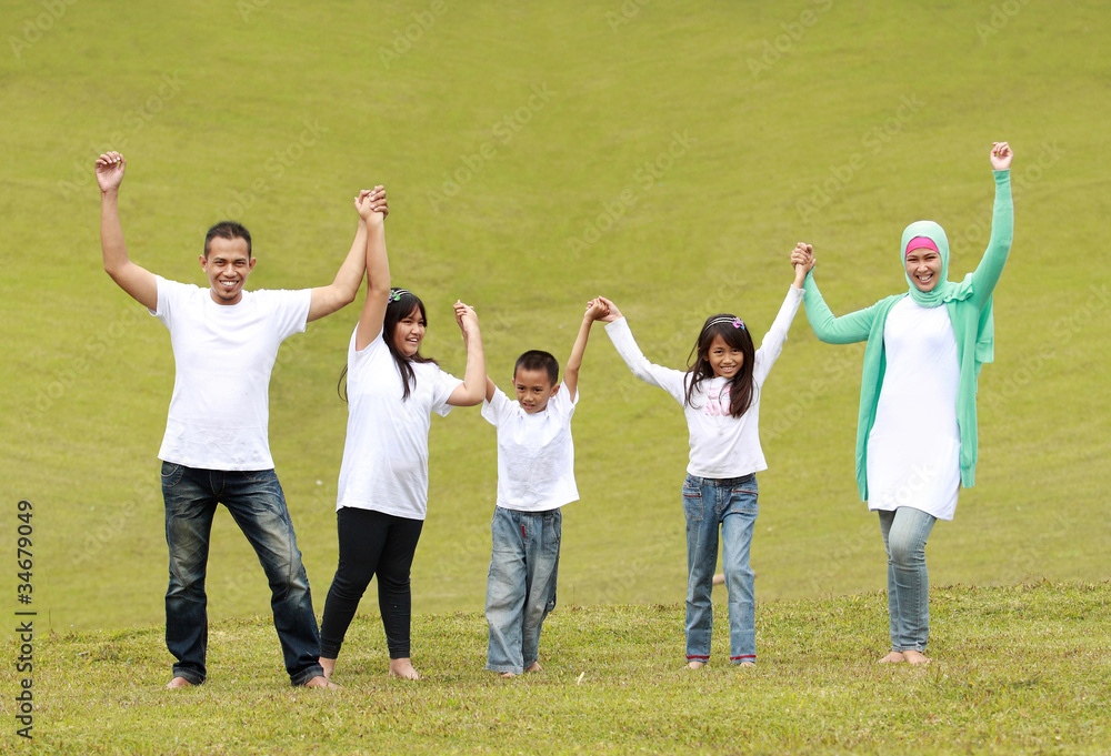 Happy family raise hand together