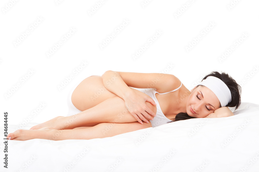 Obraz premium Cute woman sleeps on the white bed