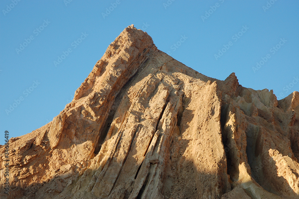 Geological layers on the top of mountain in Negev Desert.